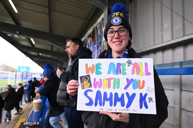 A fan holds up a poster in support of Sam Kerr