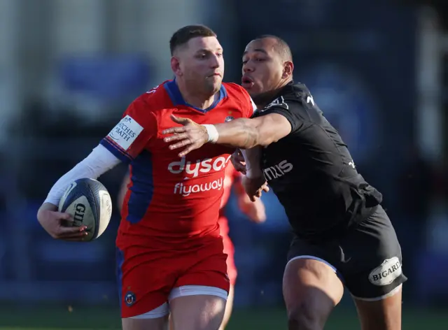 Finn Russell tackled by Gael Fickou