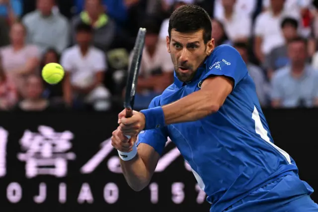 Novak Djokovic hits a backhand shot