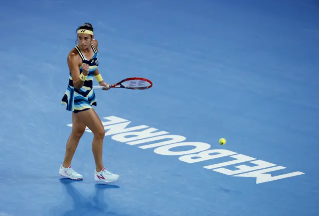 Caroline Garcia pumps her fist in celebration as the ball goes long in front of her