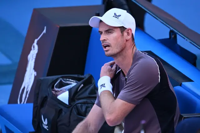 Andy Murray sitting down on the bench