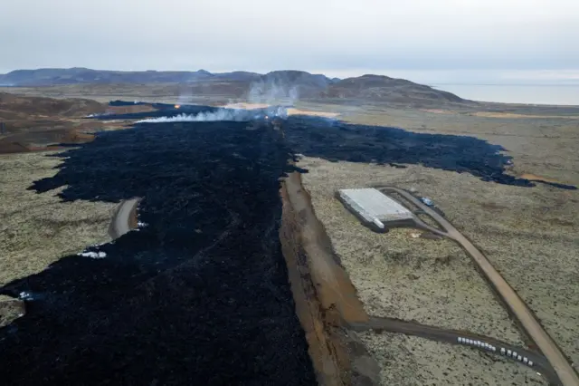 An aerial image of Grindavik where lava can be seen near houses