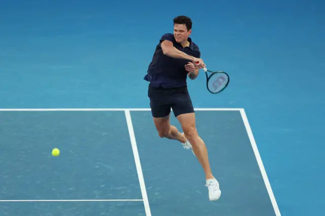 Milos Raonic hits a forehand shot