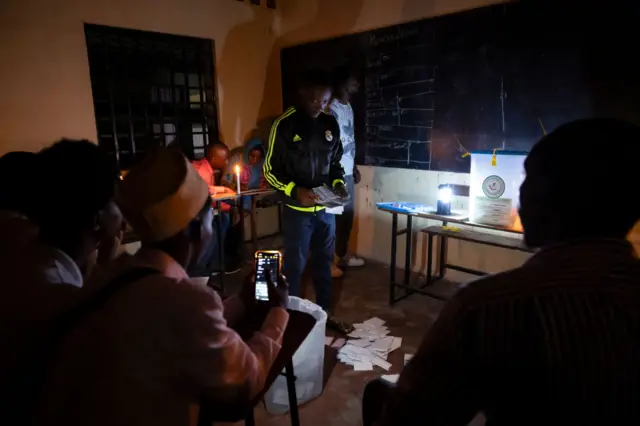 Polling station officials count votes at a polling station in Moroni, on January 14, 2024, on the presidential election day.