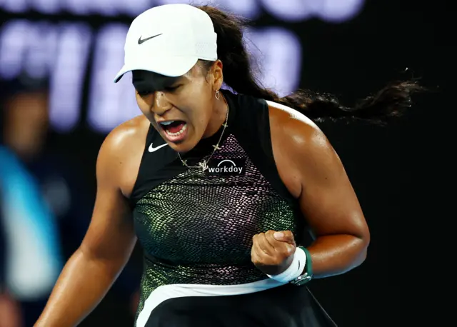 Naomi Osaka roars and pumps her fist in celebration