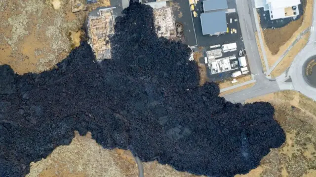 An aerial image of Grindavik where lava can be seen near houses