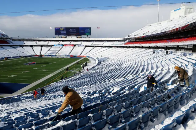 Fans shovelling the snow at Buffalo's Highmark Stadium