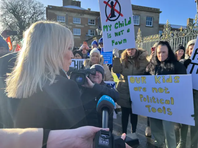 Michelle O'Neill stops to talk with protestors