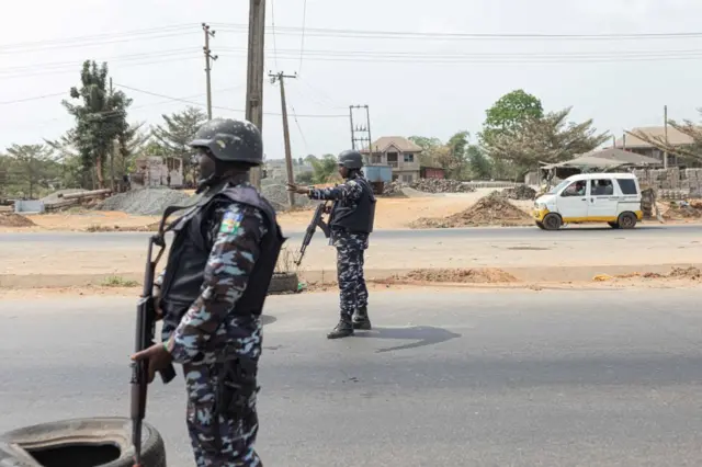 Nigerian police officers stop cars at a security checkpoint in Awka, Nigeria, on February 26, 2023