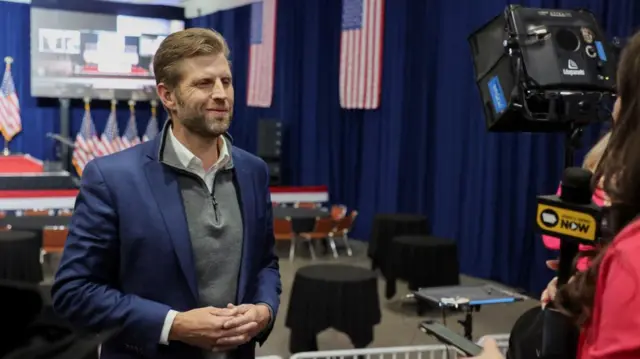 Eric Trump speaks to a reporter in Iowa