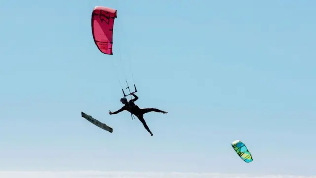 A kitesurfer loses control of his board, on a sunny day at Bloubergstrand beach in Cape Town, South Africa, January 15, 2024