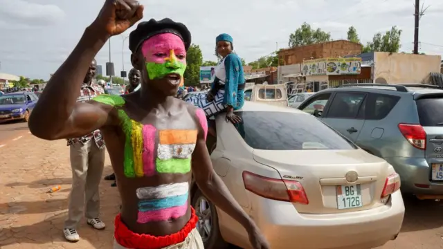 A supporter of the military painted the flags of Niger and Russia on his body during a rally in Niamey, Niger, 06 August 2023