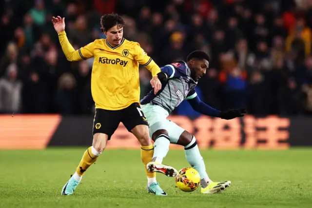 Hugo Bueno and Shandon Baptiste battle for the ball