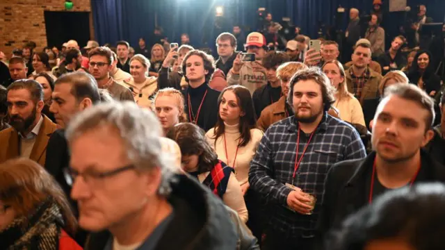 Supporters of Republican presidential candidate and businessman Vivek Ramaswamy react at his Iowa caucus night watch party