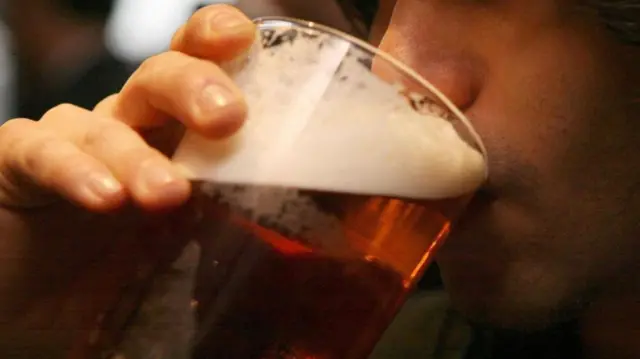 Man drinking a pint of beer