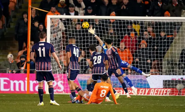 Albie Morgan's shot rises high into the roof of the net.