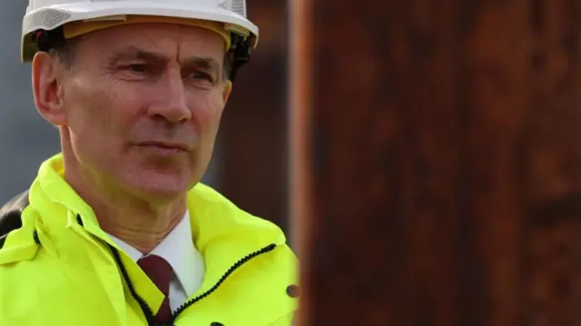 Jeremy Hunt wearing a hard hat and high vis jacket