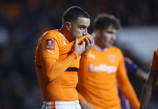 A Blackpool player wipes his face after the side concede the third goal.