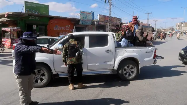 Pakistani guards check people at a roadside checkpoint in the Balochistan province capital Quetta on 17 January.