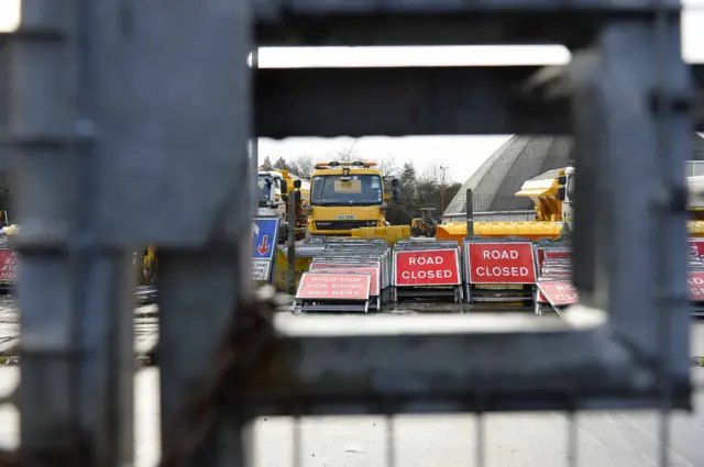 Gritting lorries behind closed road signs