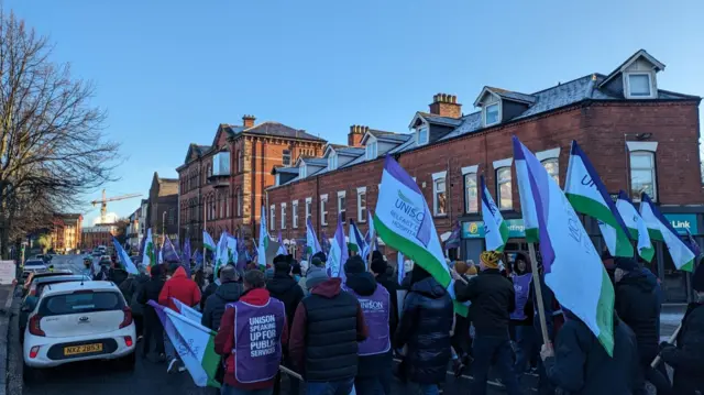 Strikers march towards the city centre