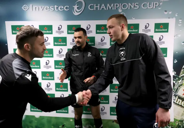 Referee Pierre Brousset conducts the pe-match formalities as Connacht captain Caolin Blade and Bristol skipper Fitz Harding shake hands