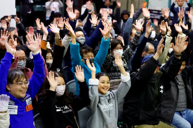 People celebrate the landing at a public viewing event in Sagamihara, south of Tokyo