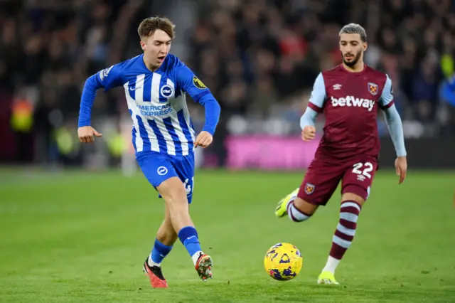 Hinshelwood plays the ball inside as Benrahma watches on.