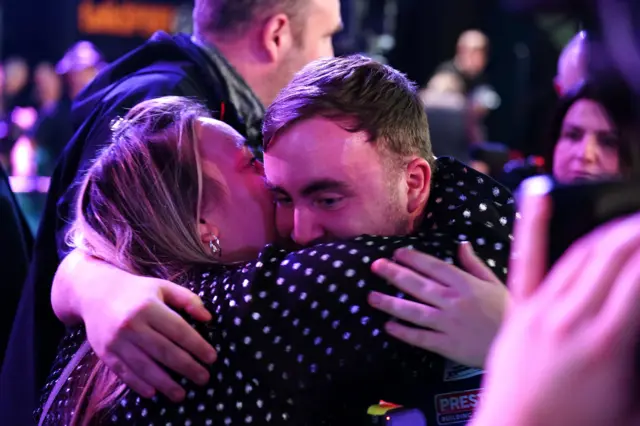 Luke Littler hugs his mum after beating Rob Cross in the World Darts Championship semi-final