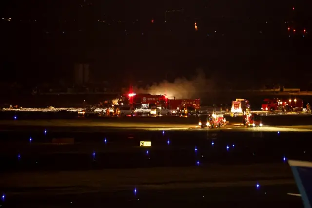 Firefighters work in the night at the airport