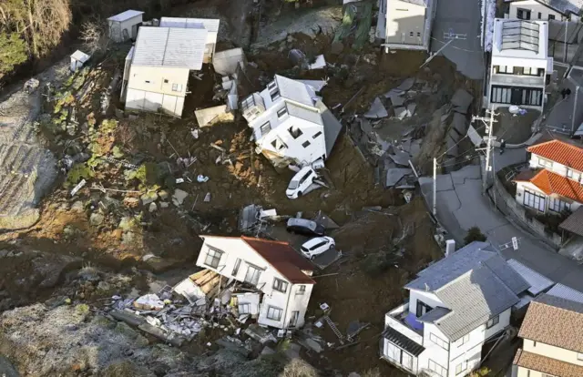 Collapsed houses, cars and roads in Kanazawa shown from above