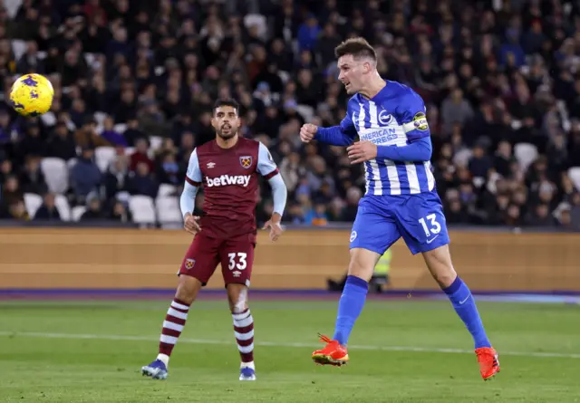 Pascal Gross heads at goal as Emerson watches on.