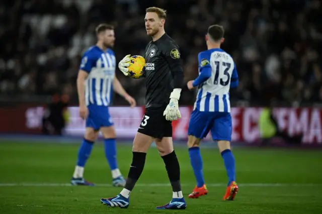 Steele walks with the ball in hand before re-setting for a goal kick.