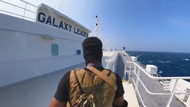 A Houthi fighter stands on the Galaxy Leader cargo ship in the Red Sea in November