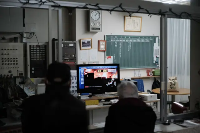 Residents sheltering in a gymnasium in Ishikawa Prefecture watch the news