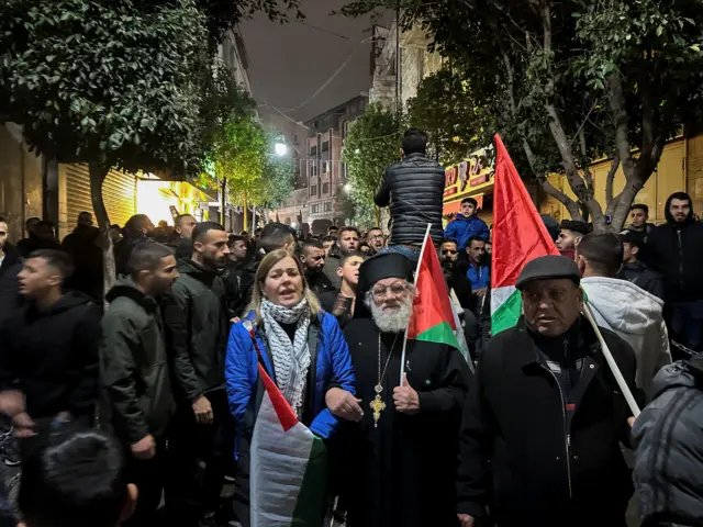 People holding flags gathering in the streets