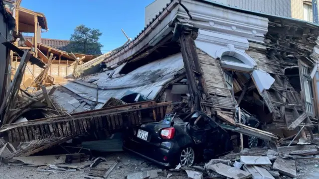 Car buried under rubble after earthquake in Japan