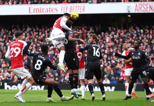 Gabriel leans on a  defender to win a header at a corner to score for Arsenal.