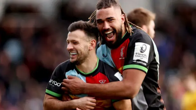 Danny Care of Harlequins celebrates scoring their team's fourth try with team mate Chandler Cunningham-South