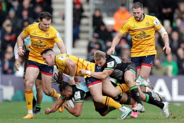 Chandler Cunningham-South and Jack Walker with Ulster's James Hume.