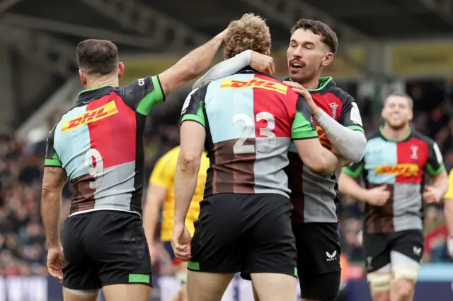 Louis Lynagh celebrates with Nick David after scoring a try.