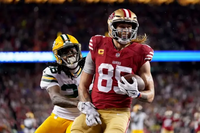 George Kittle celebrates a touchdown against the Green Bay Packers