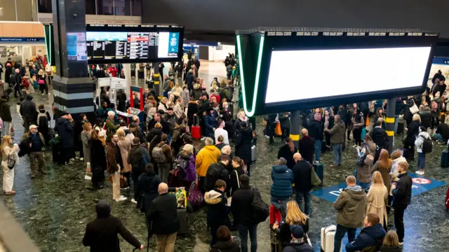 Passengers at Euston station, London, amid train delays caused by Storm Isha