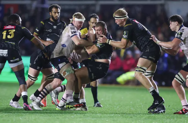 Aaron Wainwright attempts to hold up the tackle