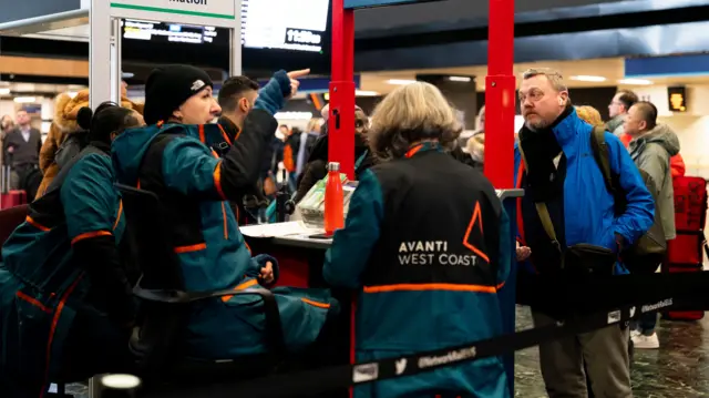 Passengers at Euston station, London, following train delays as Storm Isha has brought severe disruption to rail services.