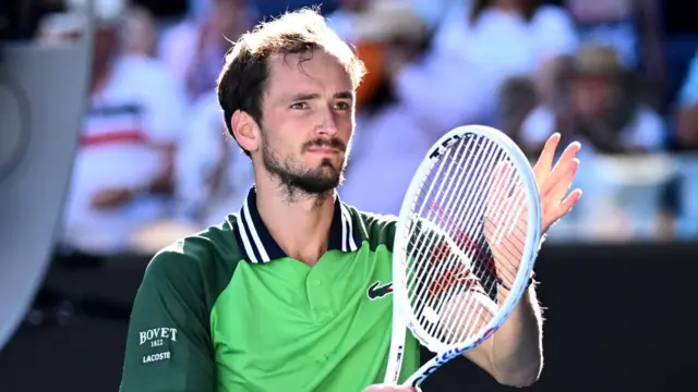 Daniil Medvedev claps with his racquet