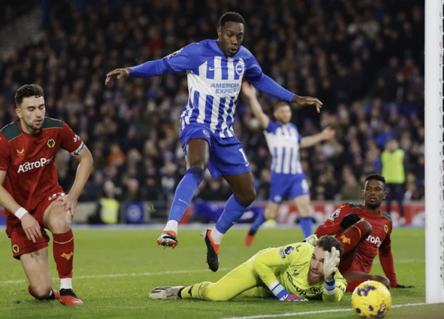 Jose Sa, Max Kilman and Nelson Semedo in action as Danny Welbeck hurdles the goalkeeper