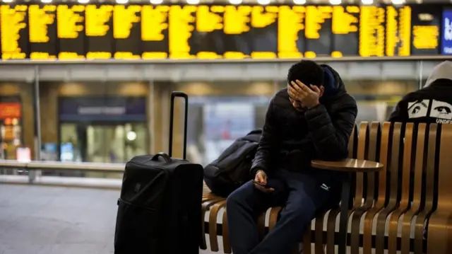 Passengers wait for train services at King's Cross station as Storm Isha disrupts rail, road, and air travel across Britain and Northern Ireland, in London, Britain