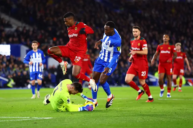 Jose Sa of Wolverhampton Wanderers claims the ball at the feet of Nelson Semedo