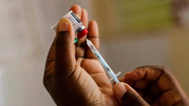 A nurse fills a syringe with malaria vaccine before administering it to an infant at the Lumumba Sub-County hospital in Kisumu, Kenya, July 1, 2022.